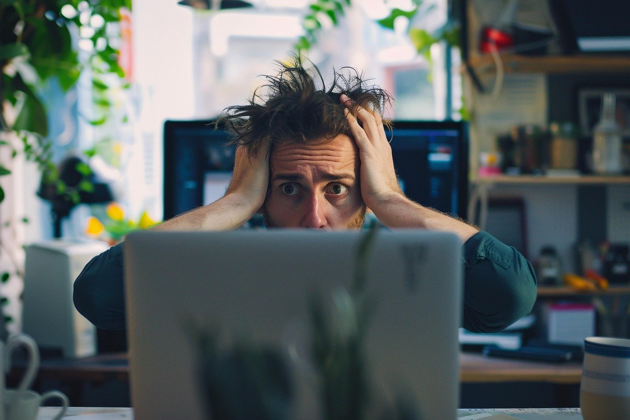 a frustrated man with hands on head