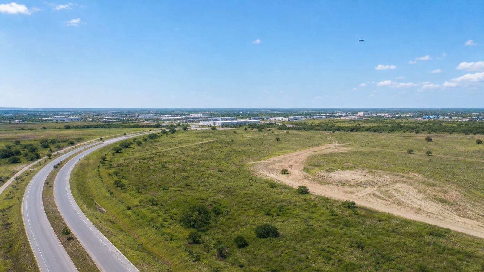 Aerial view of a development site with roads and open parcels, illustrating land-development video planning.